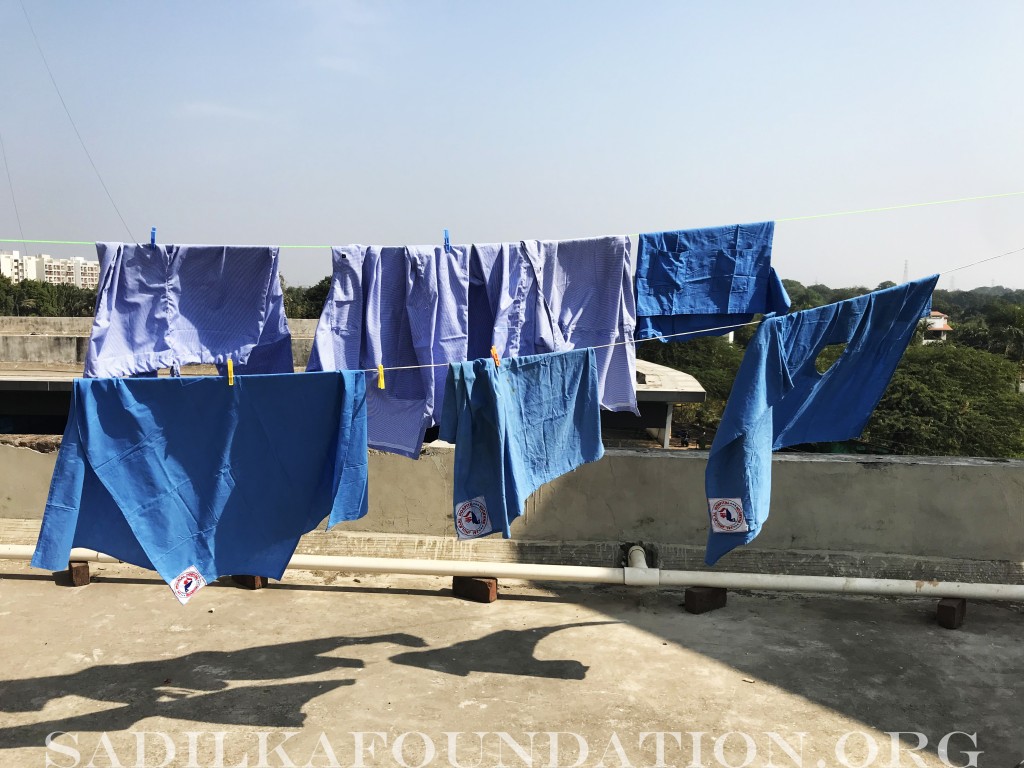 Surgical scrubs and drapes were hand-washed daily by local camp volunteers and hung out to dry on the rooftop of the hospital.