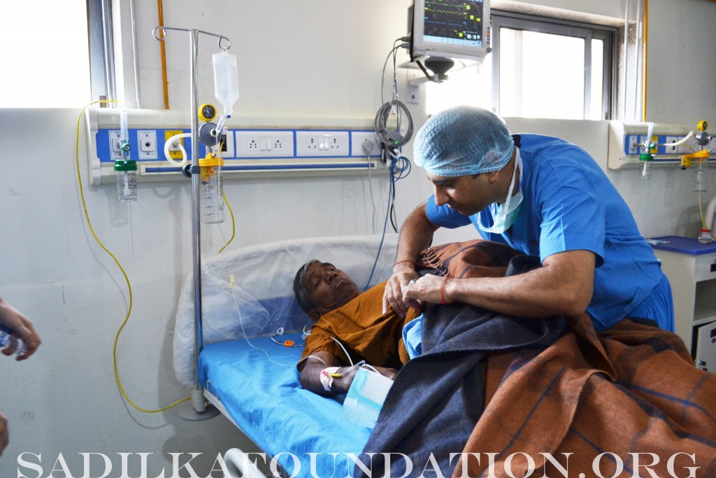 Dr. Gupta performing a postop wound check on one of his patients.