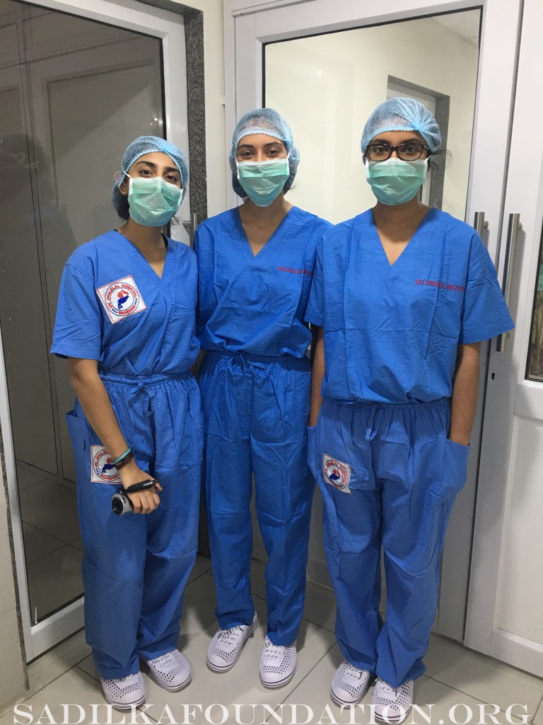  Kasmira, along with Monika and Pooja is about to enter the OR where she will videotape her dad  performing a percutaneous nephrolithotomy procedure.