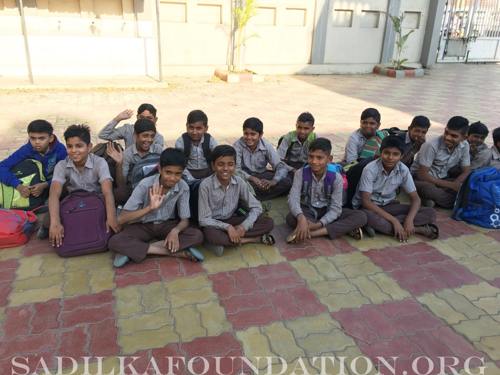 Boys sitting outside for recess.